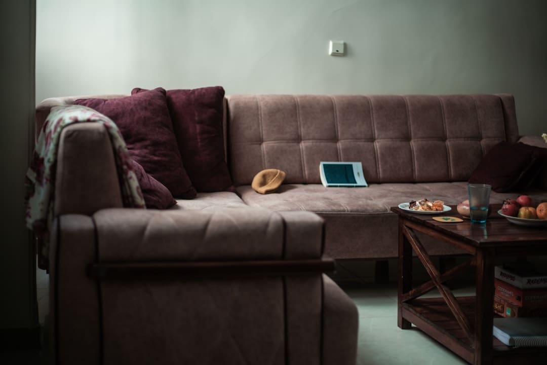 landlord questions. A sectional sofa with pillows and a tablet on it.