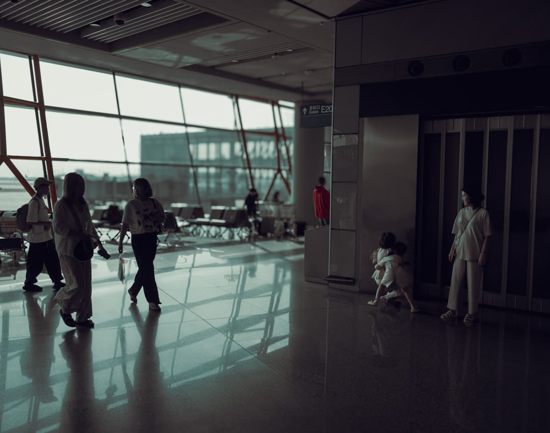 road trip service dog — A group of people walking through an airport