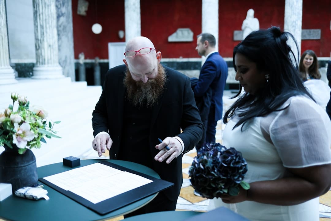 support animal laws — Couple signing wedding papers with guests watching