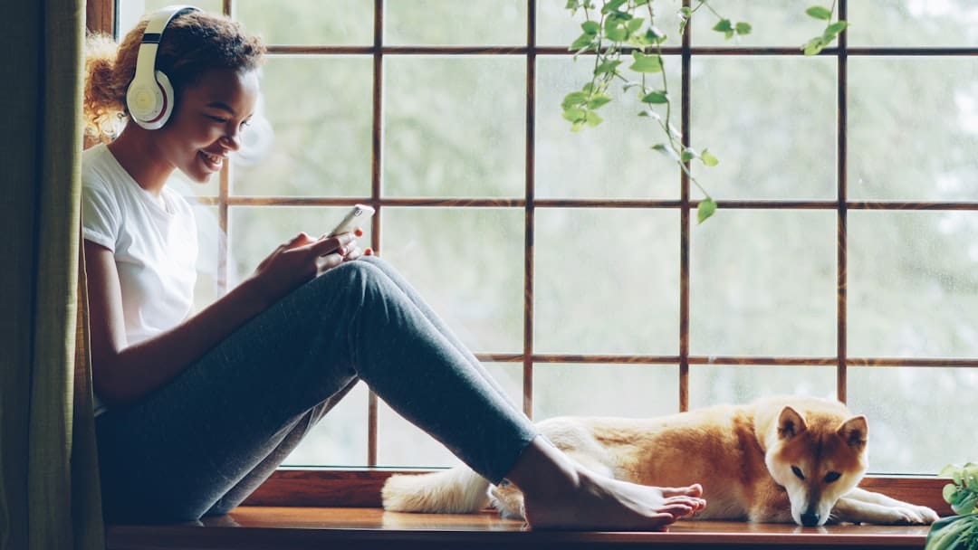 support animals. Woman listens to music with her dog.