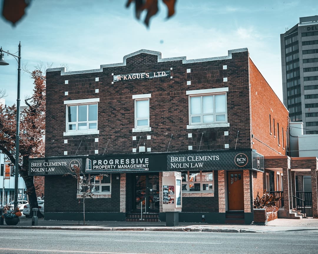 support animal accommodation — Brick building with "progressive property management" sign.