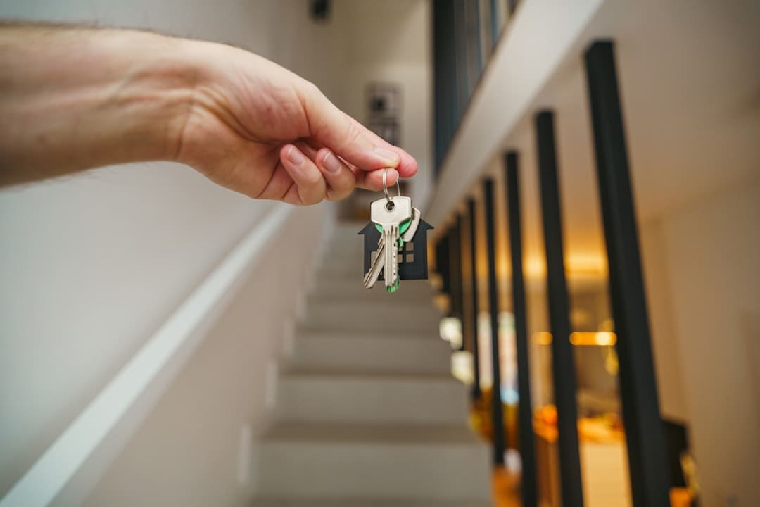 support animal housing rights — Here's a possible caption: keys being held in front of a staircase.