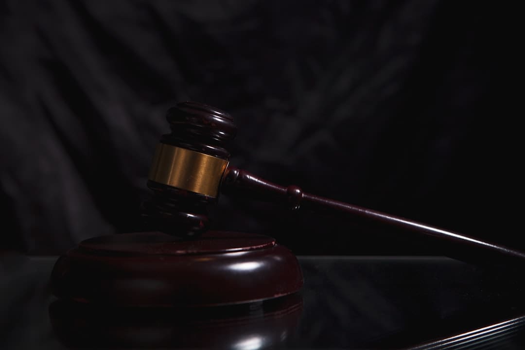 california support animal — A wooden gavel rests on a dark surface.