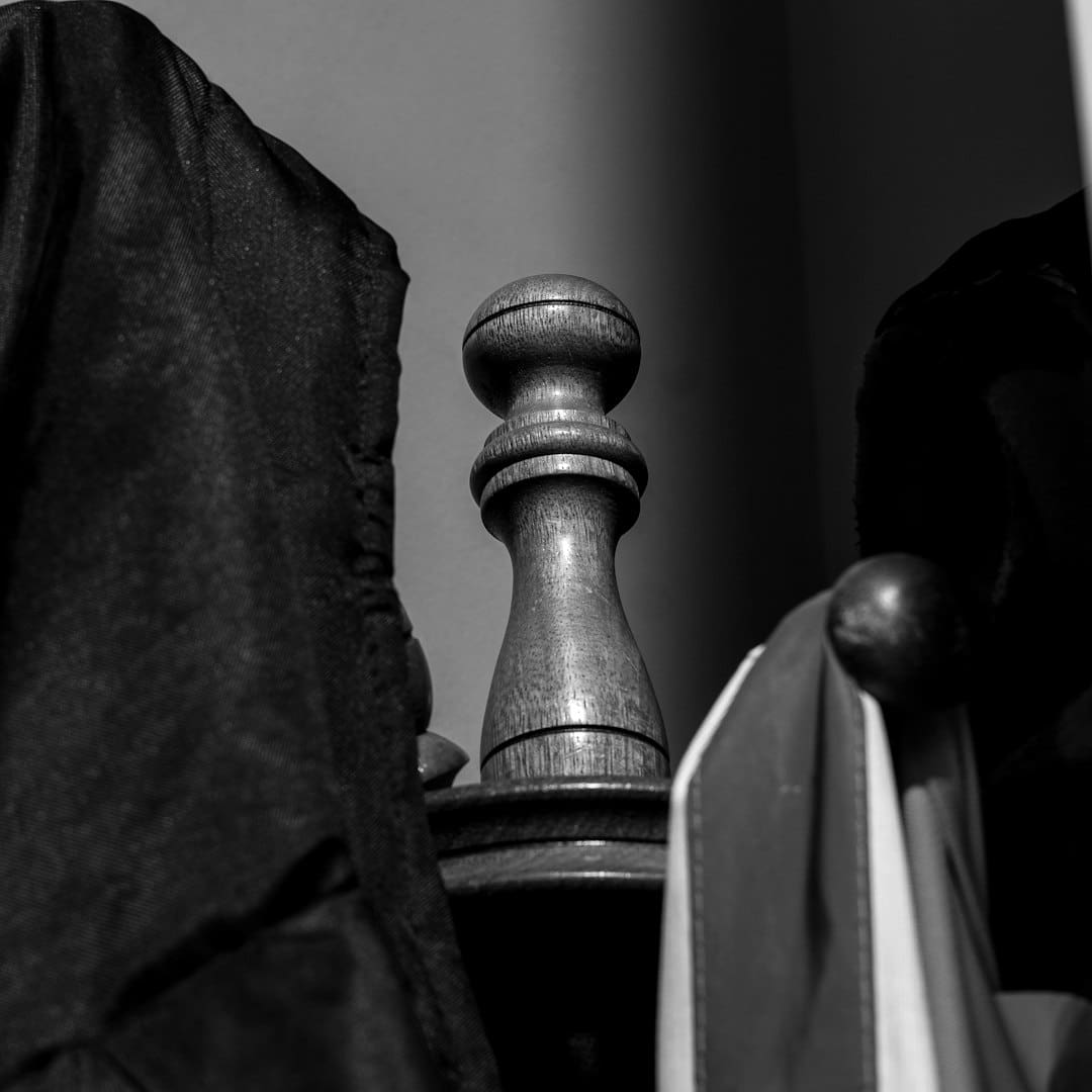 Illinois support animal — Close-up of a wooden finial between hanging clothes.