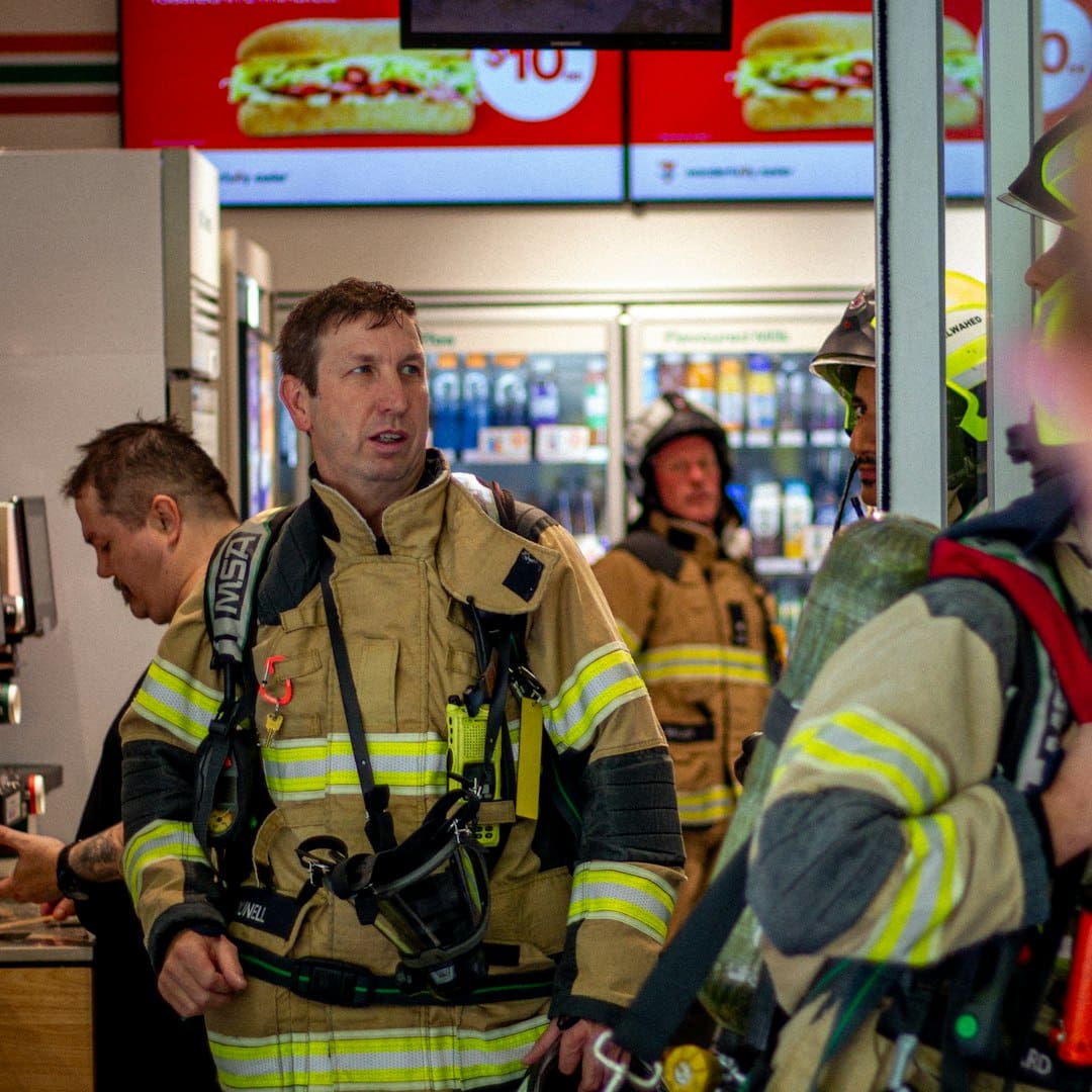 owner trained service dog — Firefighters in uniform inside a store