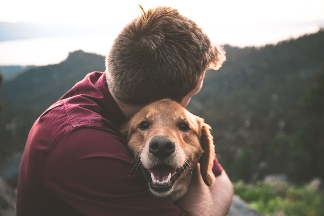 panic disorder support animal — photo of man hugging tan dog
