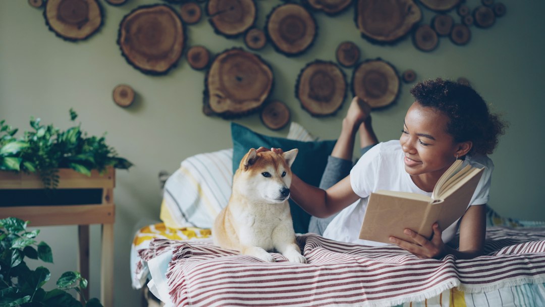 support animal letter — Girl pets a dog while reading in bed