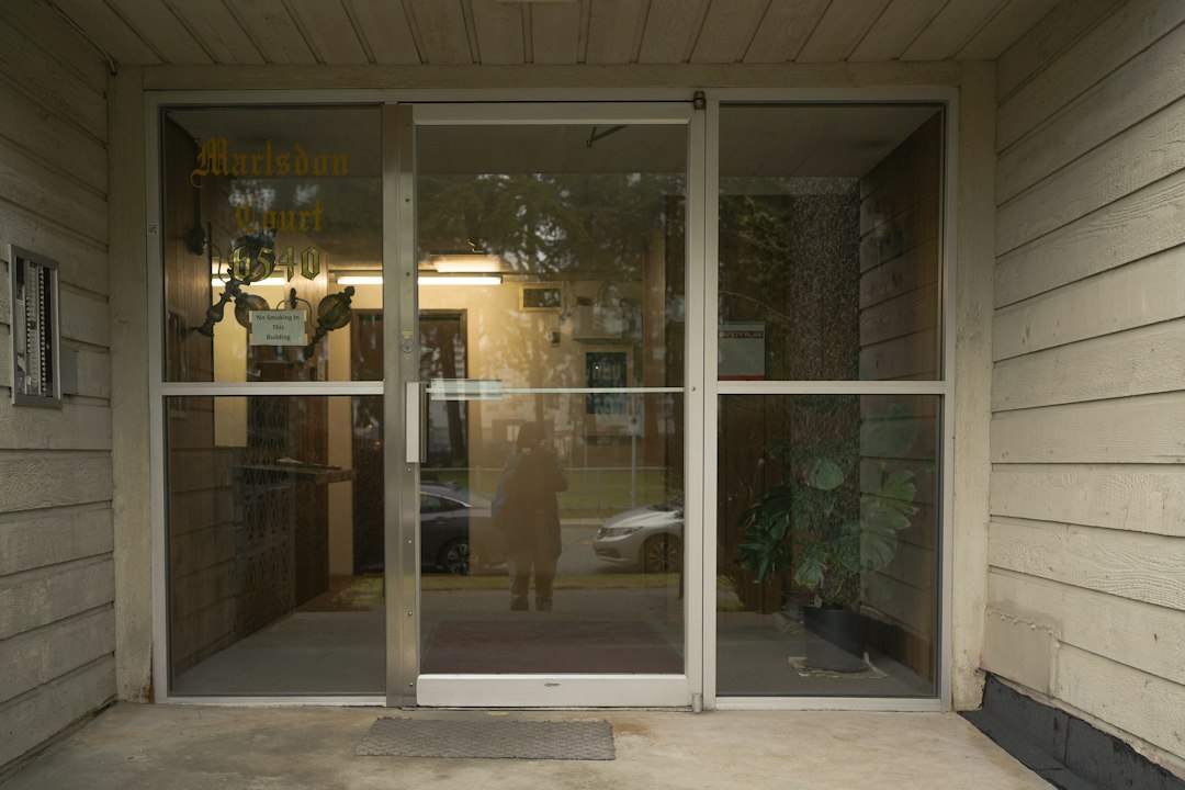 roommate allergies — a person standing in a doorway of a building